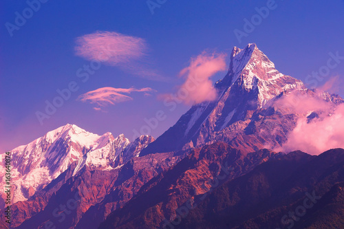 Machapuchare mountain sunset view from Poon Hill with blue sky background. Nepal landscape, Annapurna circuit, Himalaya, Asia. Horizontal view photo