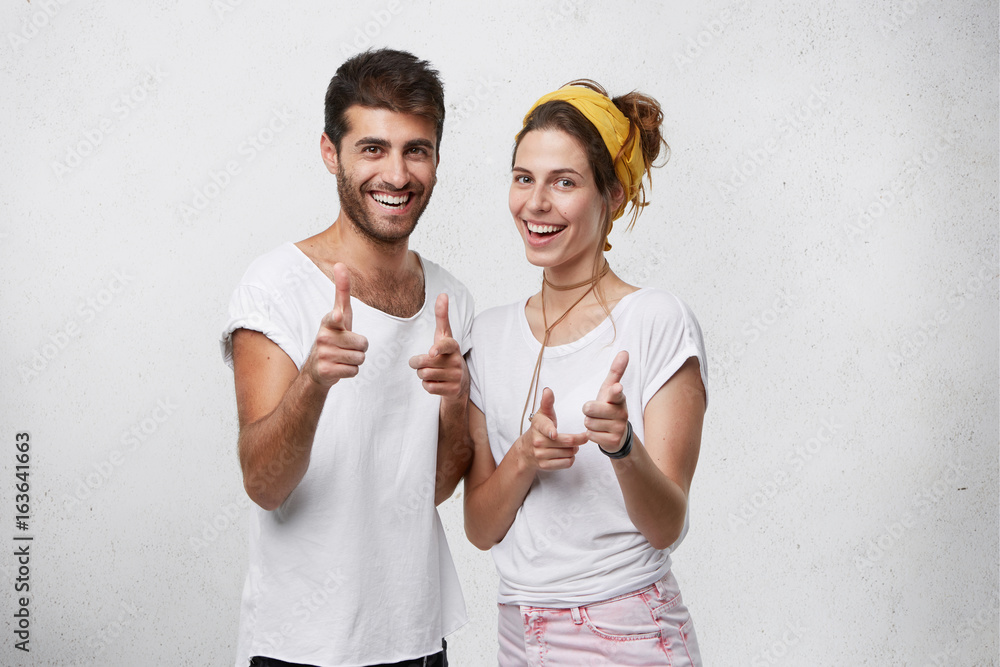 Male and female best friends with positive expression looking with ...