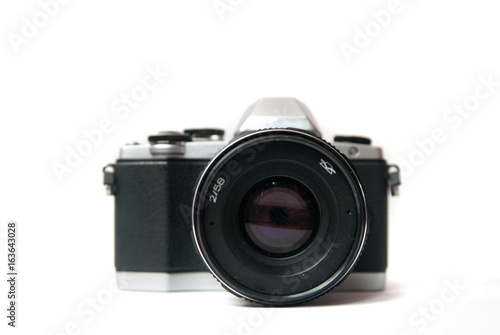 Retro camera with metal lens on white background