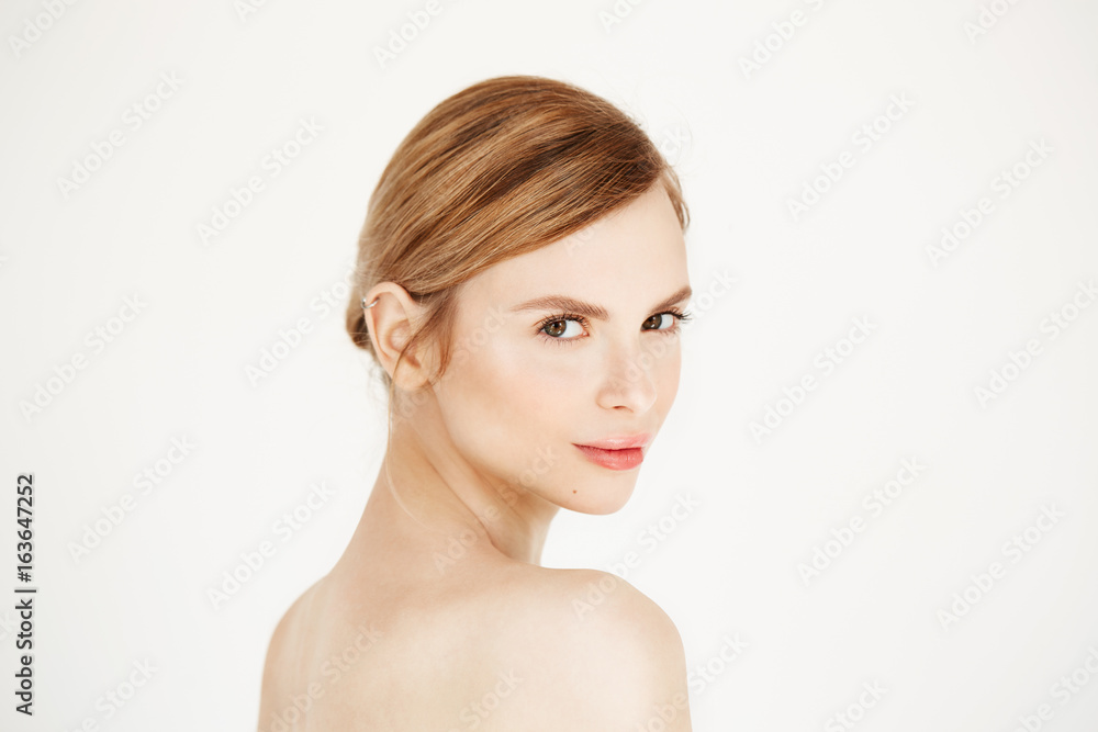 Portrait of young beautiful girl with natural make up smiling looking at camera over white background. Cosmetology and skincare. Portrait of young beautiful girl with natural make up smiling looking at camera over white background. Cosmetology and skincare.