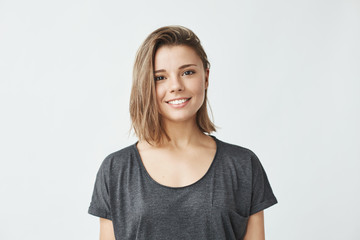 Portrait of young beautiful cute cheerful girl smiling looking at camera over white background.