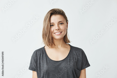 Portrait of young beautiful cute cheerful girl smiling looking at camera over white background.