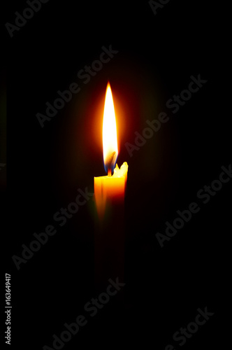 isolated Burning Candle In The Dark