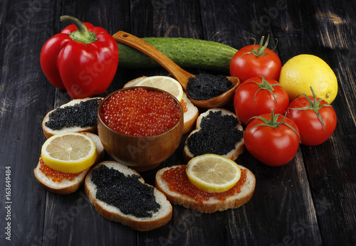 caviar and vegetables on wooden background