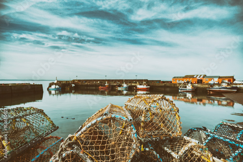 Lobster pots stacked onto each other in a small fishing port. Port Seaton, Scotland, UK