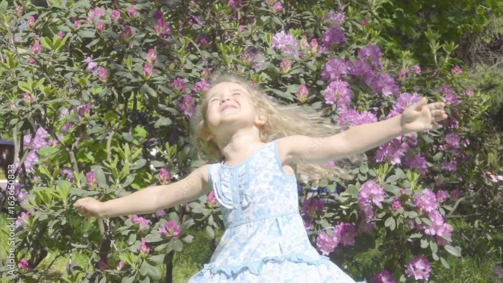 Cute Little Girl Having Fun and Spinning in Park . Slow Motion. Cute Little Girl Having Fun and Spinning in Park . Slow Motion.