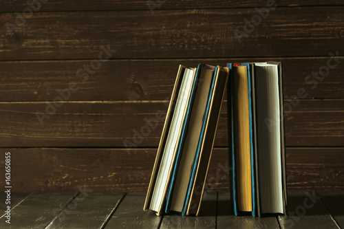 Books close up on old wooden table