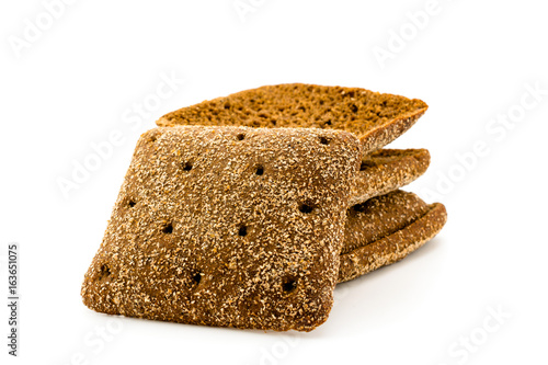 Sliced black bread on white background
