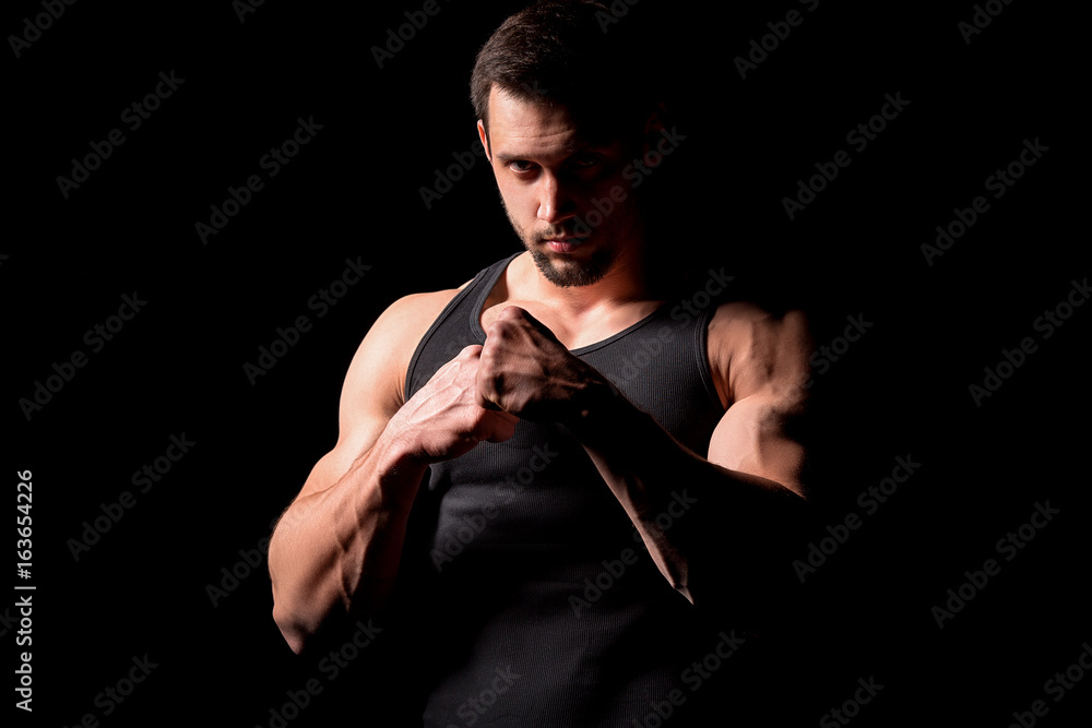 Fighter silhouette. Handsome athletic man in boxing stand on a dark background. Fighter silhouette. Handsome athletic man in boxing stand on a dark background.
