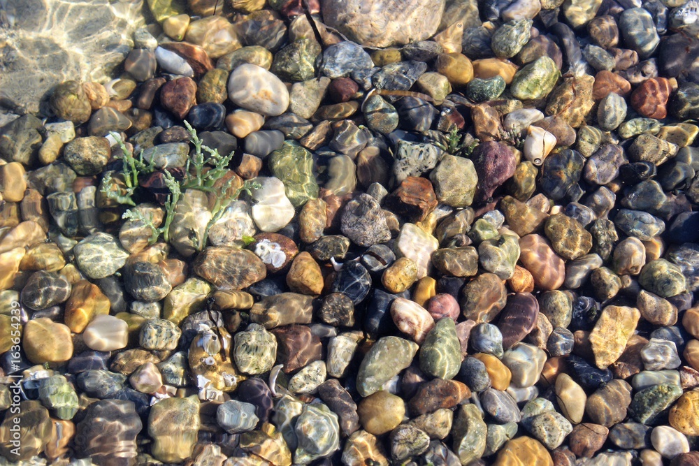 Stones on sea floor under the wave Stones on sea floor under the wave
