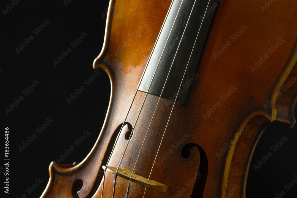 Old violin on a black background Old violin on a black background