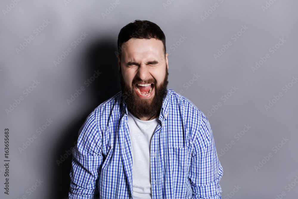 Obraz premium Portrait of angry crying bearded man
