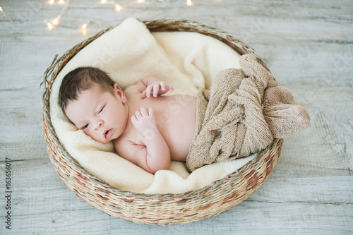 newborn baby lying in basket
