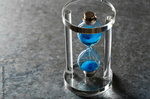 Time is passing. Blue hourglass close up © fotofabrika