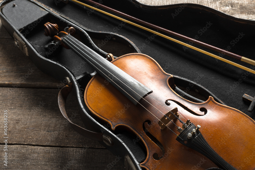 Violin on a wooden textured table Violin on a wooden textured table