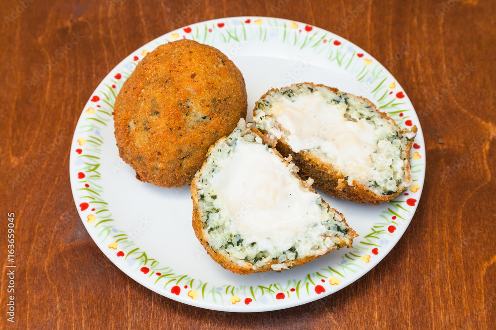 spinach stuffed rice balls arancini on wood table spinach stuffed rice balls arancini on wood table