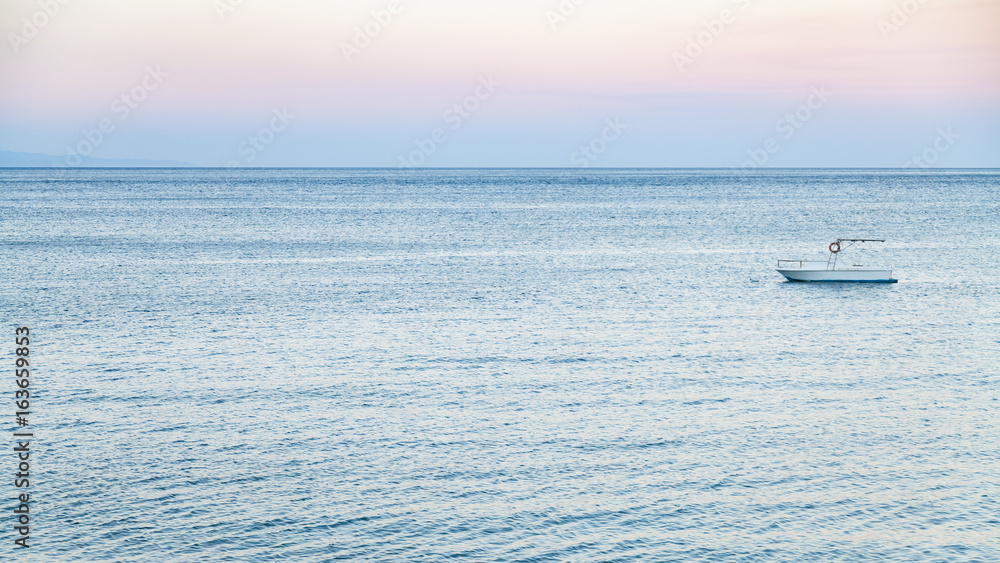 Fototapeta premium view of boat in Ionian sea in summer twilight