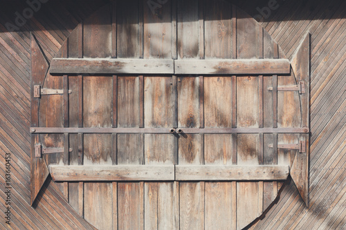 Natural wood round doors on wood planks wall, background. photo