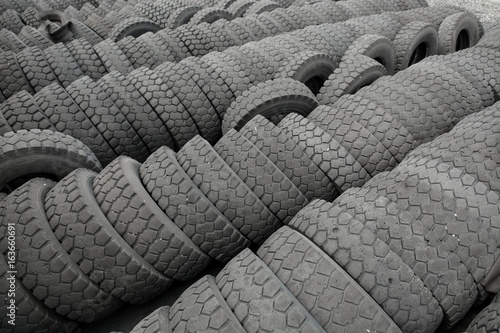 Warehouse of old used tires outdoors, old wheels