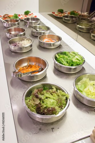 Self service salad bar with a variety of salads