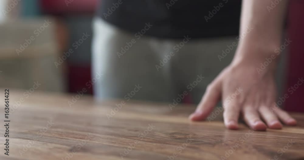 slow motion closeup shot of man put bunch of dollars on wood table slow motion closeup shot of man put bunch of dollars on wood table