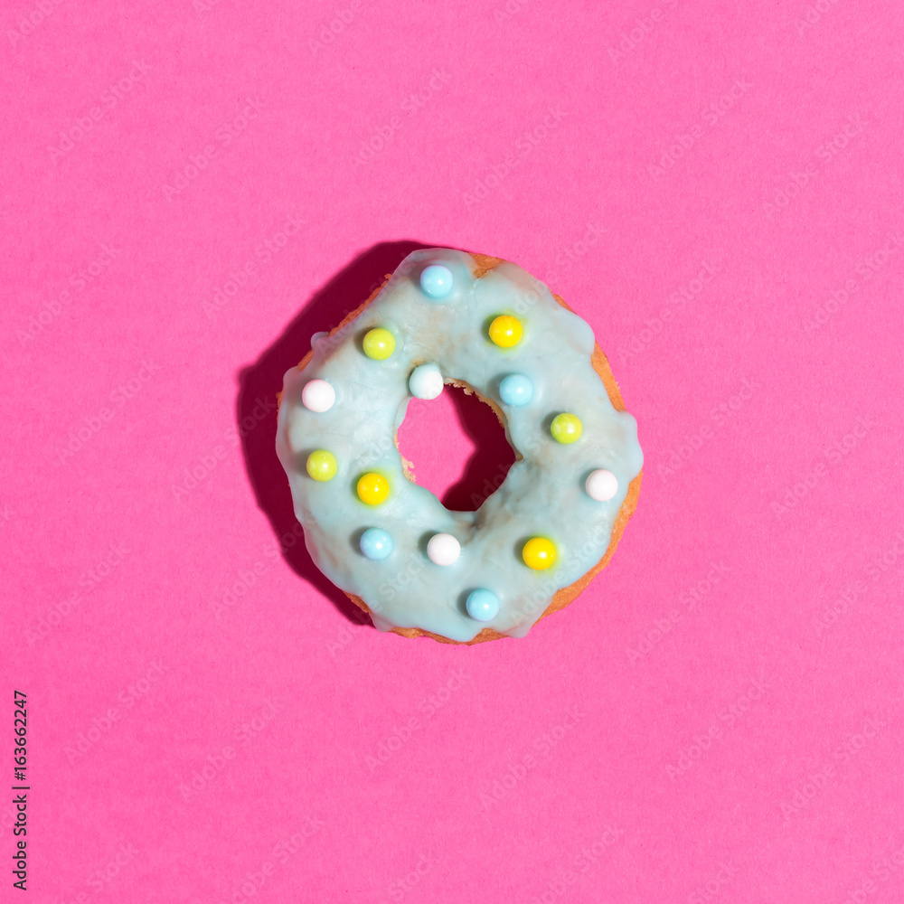 Colorful glazed dounut on a pink background Colorful glazed dounut on a pink background