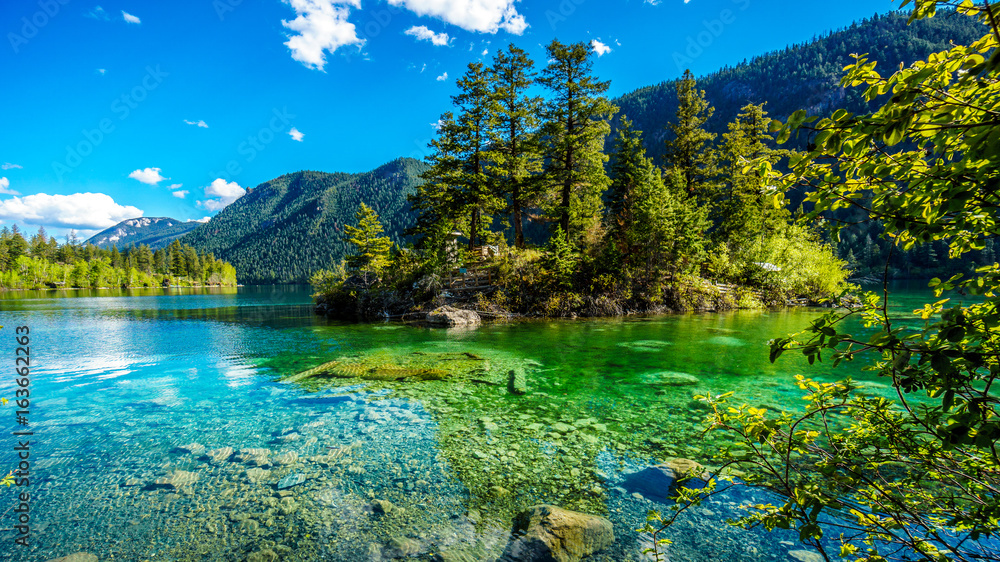 Small island in the middle of the crystal clear waters of Pavilion Lake in Marble Canyon Provincial Park, British Columbia. The lake has international fame because of freshwater microbialites
