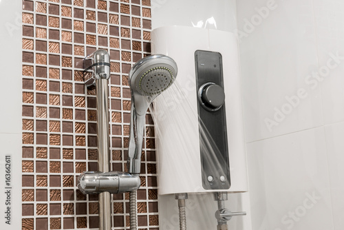 Water heater and shower spray in bathroom. Electric Water Heater Rain Shower