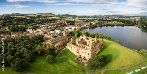 The skyline of Linlithgow including the ruins of Linlithgow Palace and St. Michael's church from the air. Linlithgow, West Lothian, Scotland.