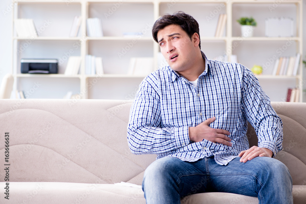 Man suffering from pain at home Man suffering from pain at home