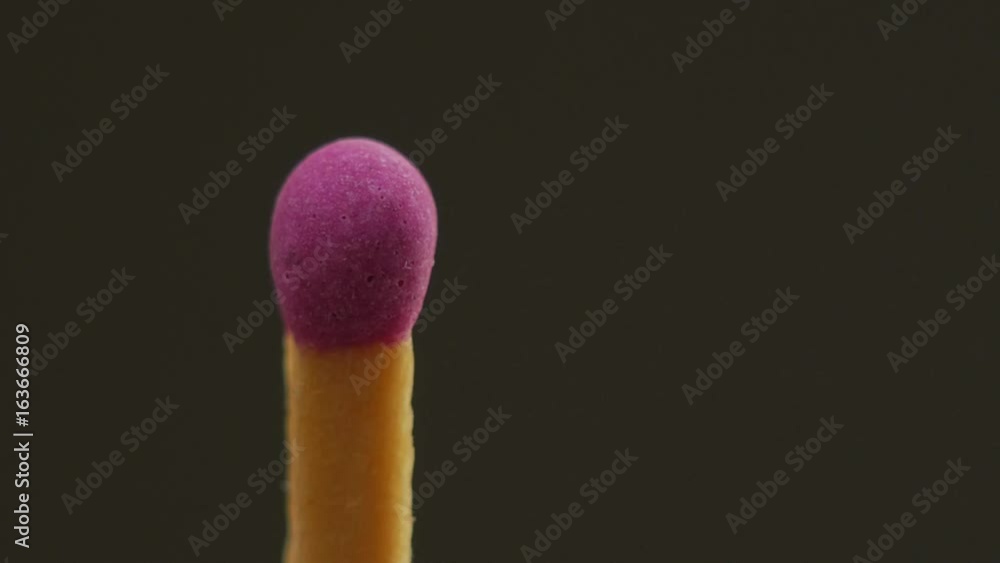 Match lighting another one, sharing fire, burning stick close up. Black background. Match lighting another one, sharing fire, burning stick close up. Black background.
