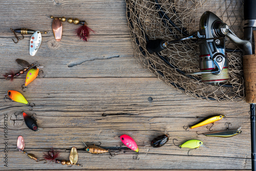 Fishing tackle on a wooden background.