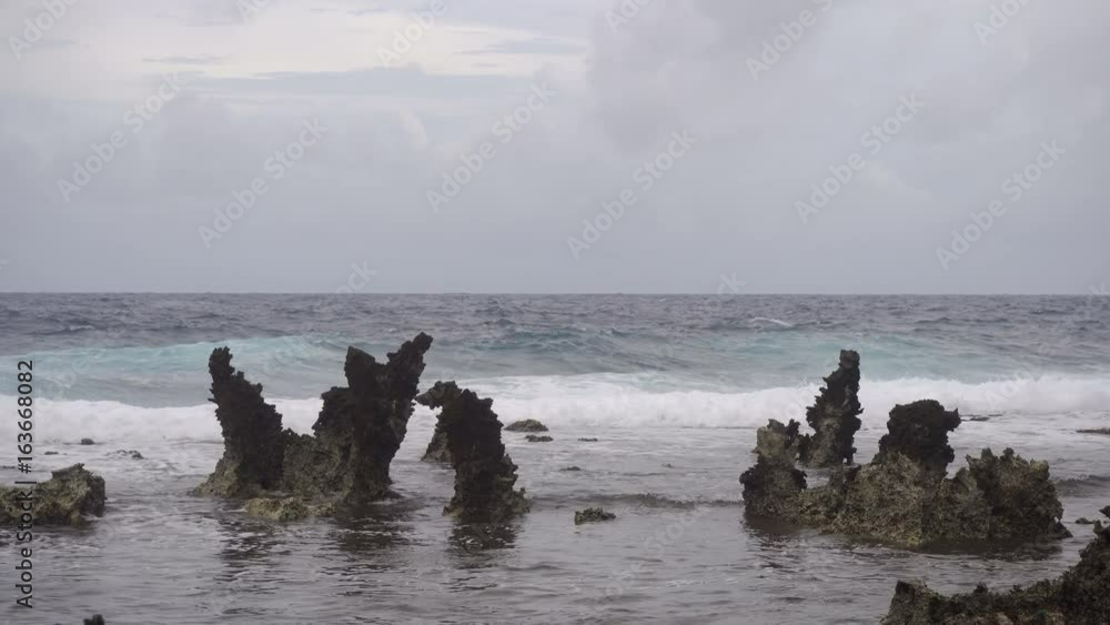 Rocky beach with blue water on tropical island. Sea rocky coast, waves breaking to the rocky shore. Viewpoint along stony beach with rocks. Stony sea beach scene. Philippines. 4K video. Travel concept Rocky beach with blue water on tropical island. Sea rocky coast, waves breaking to the rocky shore. Viewpoint along stony beach with rocks. Stony sea beach scene. Philippines. 4K video. Travel concept