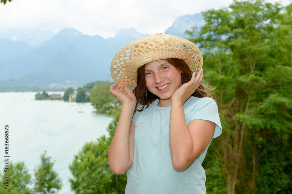 teenager girl with a straw hat in the wild
