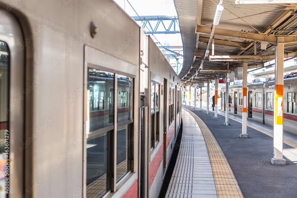 Train station in Japan quiet clean and new in urban city metro central transport system.