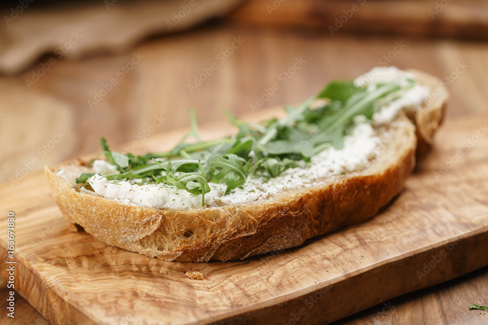 arugula on rustic bread with ricotta cheese arugula on rustic bread with ricotta cheese