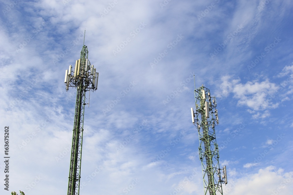 Two communications tower with blue sky. Two communications tower with blue sky.