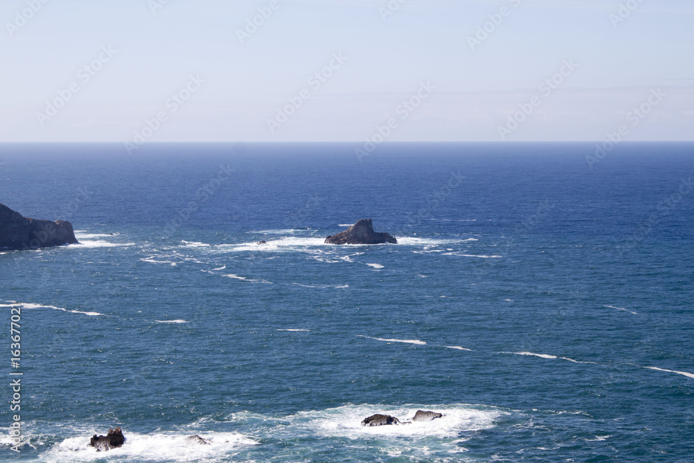 rocks in the Atlantic ocean with a blue sky, Spain