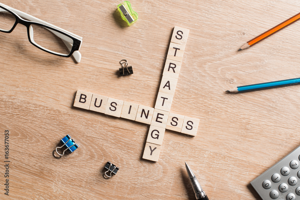 Conceptual business keywords on table with elements of game making crossword Conceptual business keywords on table with elements of game making crossword
