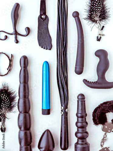 Blue dildo is among black sex toys. Adult entertainment