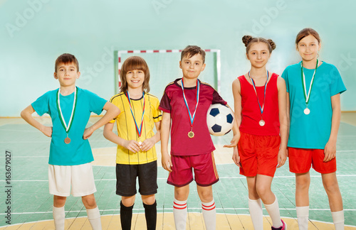 Football winners standing in line with medals