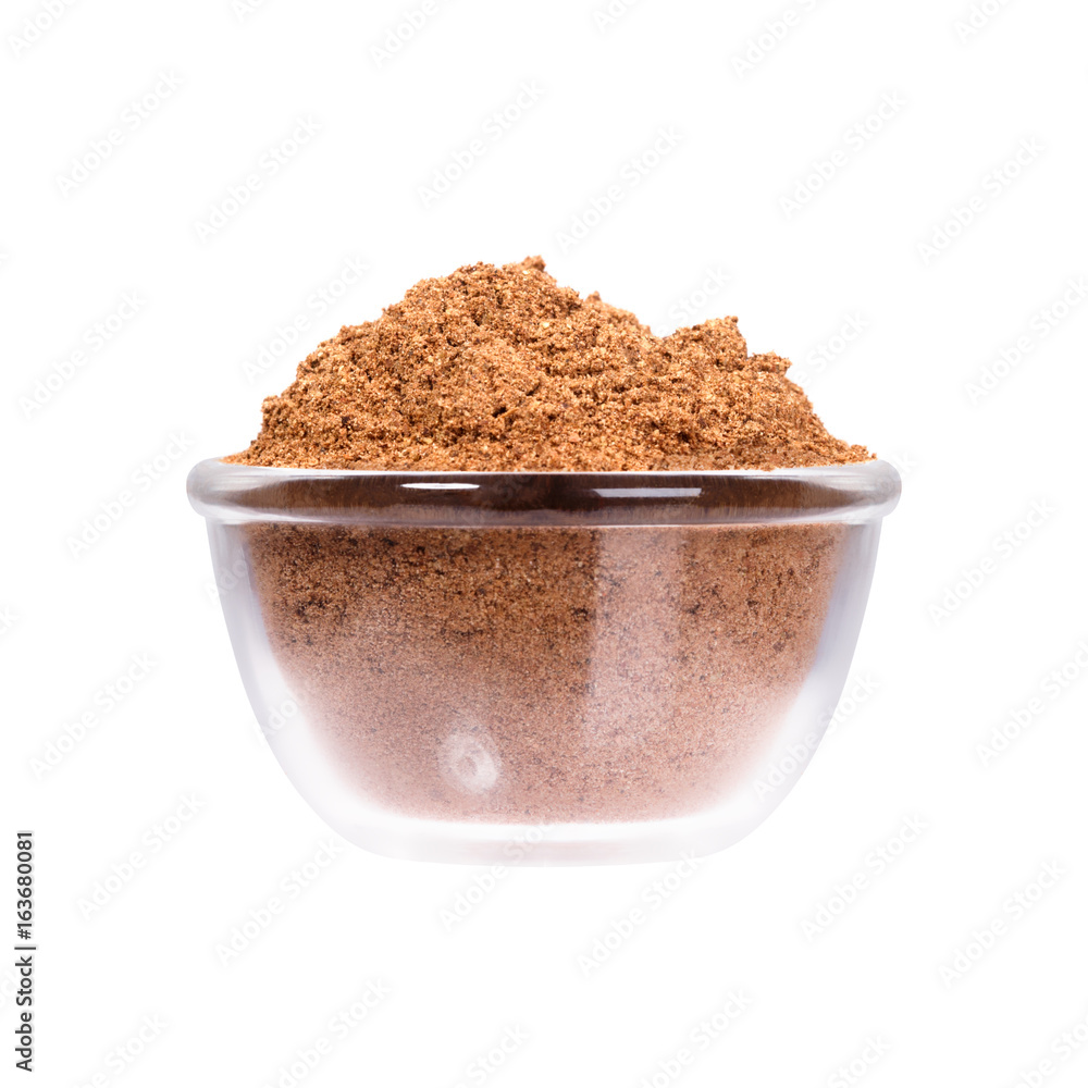 Nutmeg powder in glassy saucepan on white background. Nutmeg powder in glassy saucepan on white background.