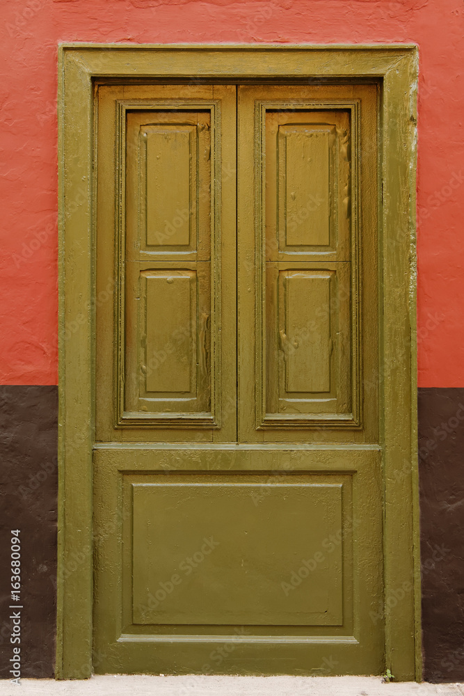 Traditional oil green exterior door frame.