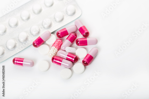 Pile of medical pills and pills on white background.