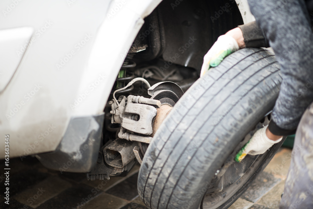 Fototapeta premium Mechanic Fixing Car Tire