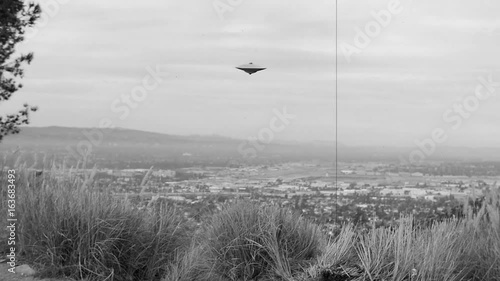 FLYING SAUCER OVER AN URBAN VALLEY photo