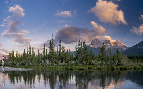 Three Sisters at sunset along the Bow River in Alberta Canada