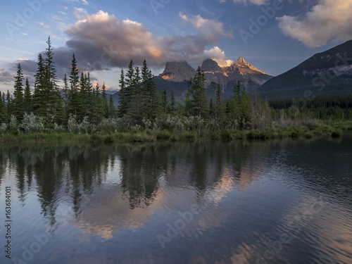 Three Sisters at sunset along the Bow River in Alberta Canada