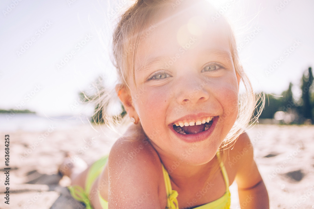 Portrait of a beautiful little girl on the beach in sunlight Stock ...