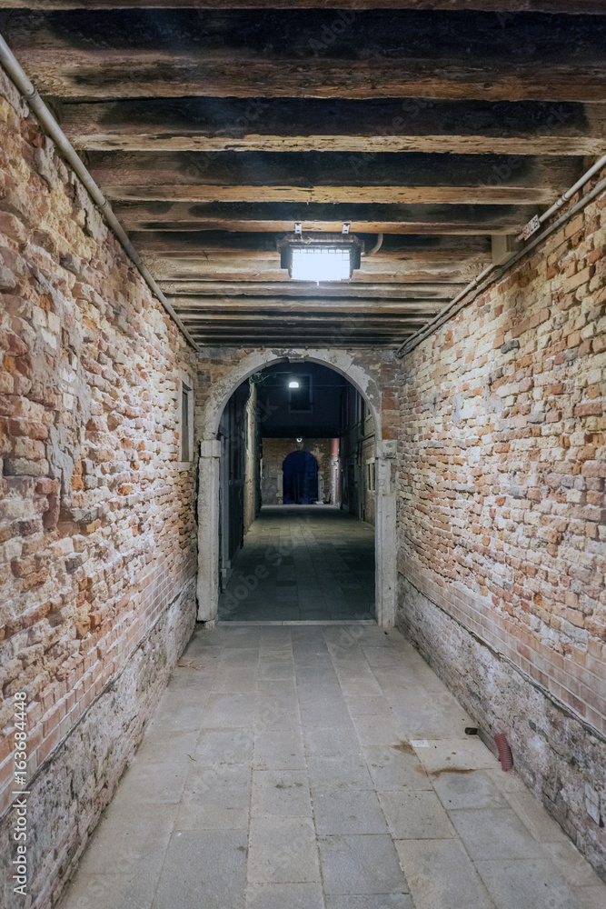 Strait tunnel very lonely in the oldest part of the city in Venice, Italy